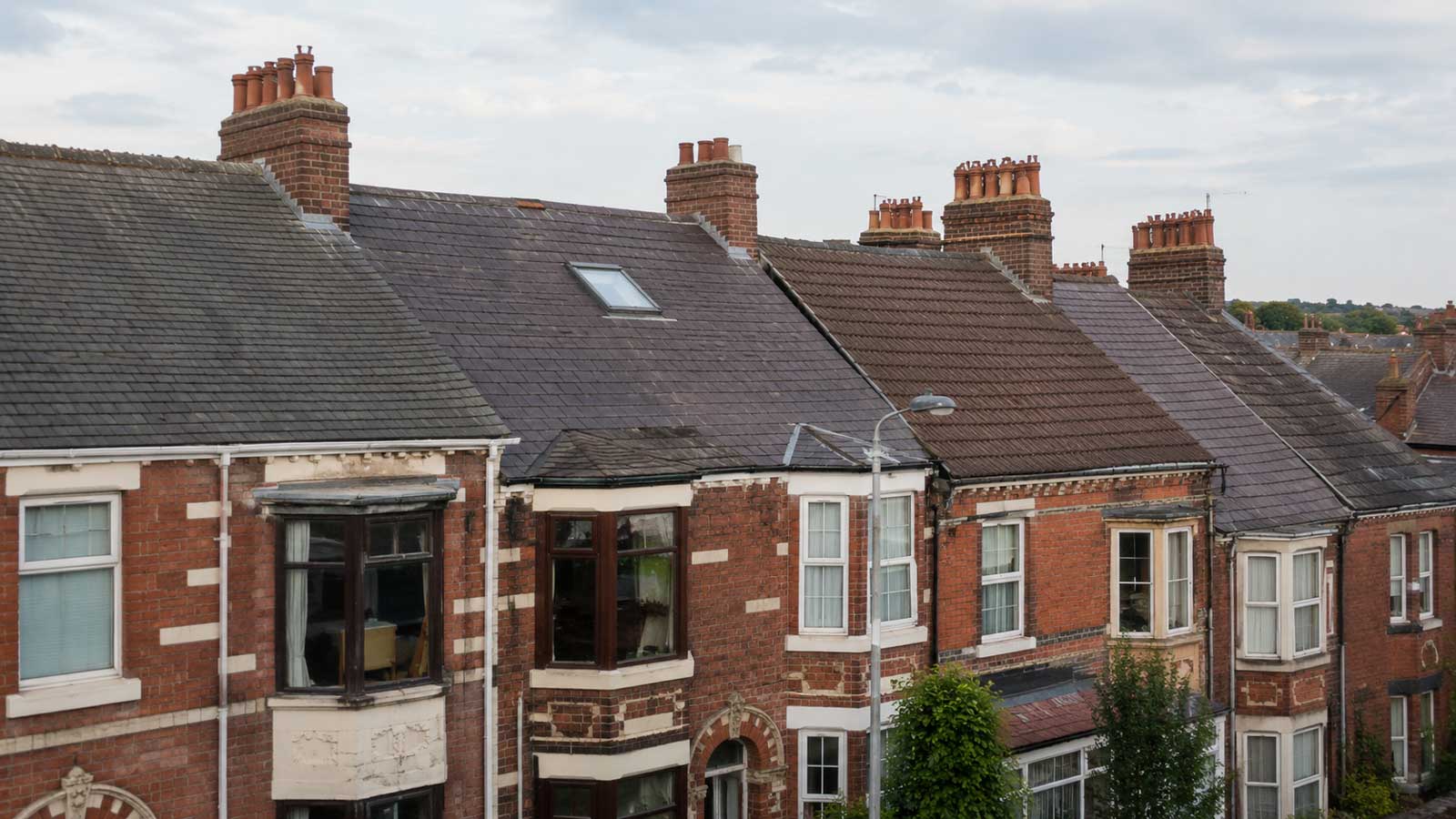 Traditional rooflines and chimneys representative of older Warrington housing